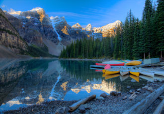 "Canoes at Moraine Lake in Banff National Park, Alberta, Canada" Photography, Various Sizes by artist Wayne Moran. See his portfolio by visiting www.ArtsyShark.com