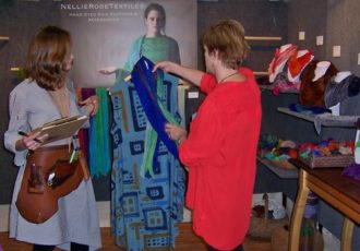 Handmade clothing booth with shopper