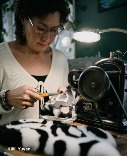 Native Alaskan artist at work on fur scarf