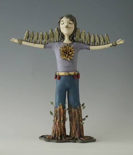 ceramic sculpture of a young woman embedded in nature