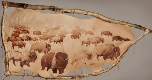 large scale pyrography on leather depicting a buffalo migration