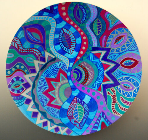 colorful painted plate in blues and reds