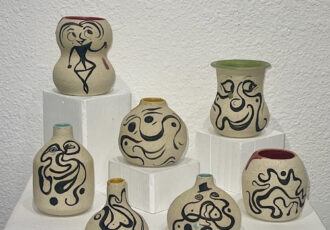 collection of handmade ceramic vases with abstract designs