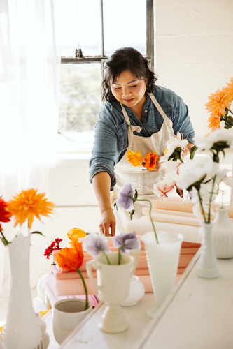 Artist working with handmade paper flowers