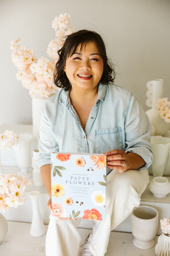 Artist Quynh Nguyen with her book on paper flower making