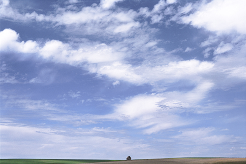 landscape photography of a barn under a big sky