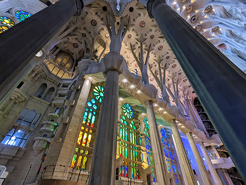 photograph of stained glass windows and soaring church walls