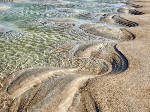 fine art photograph of a sandy beach with patterns