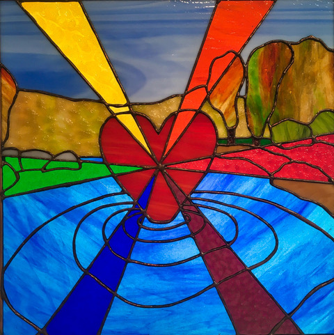 stained glass window of a river and heart